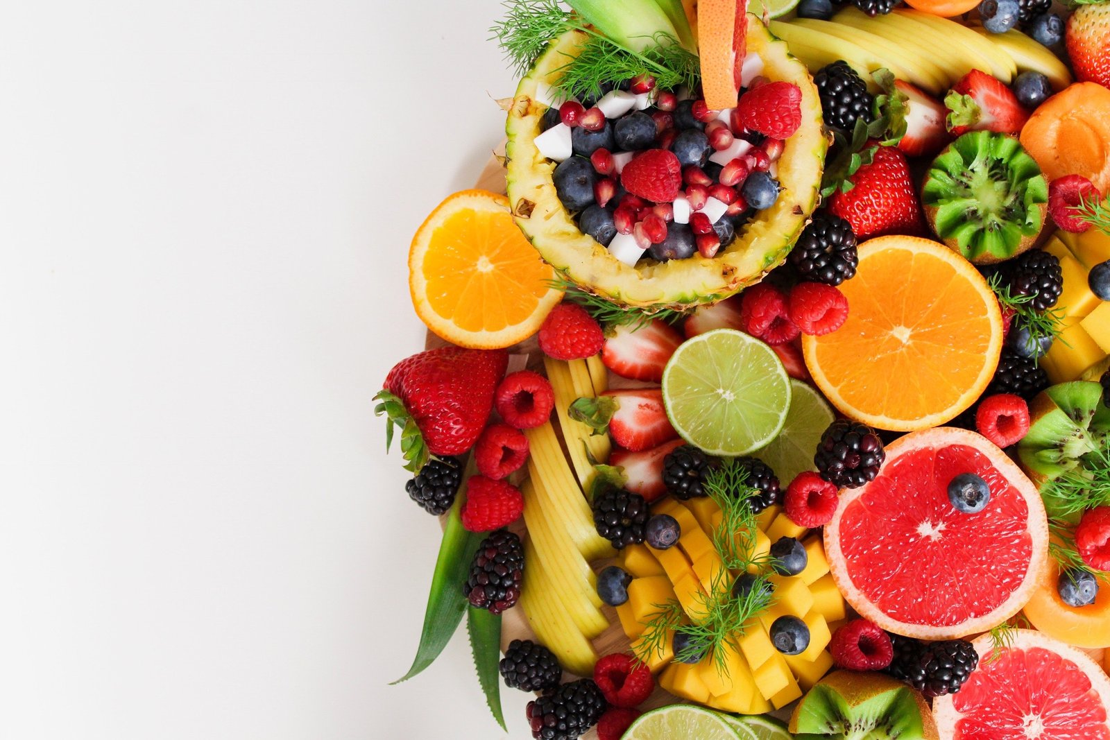 A bowl of fresh berries and citrus fruit
