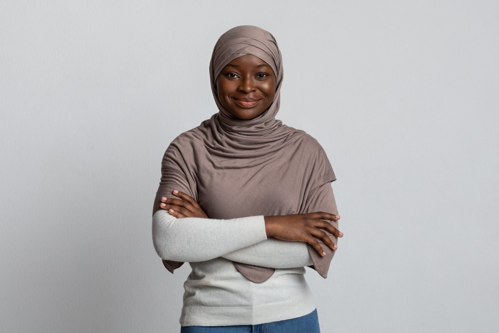 A woman standing confidently, arms folded